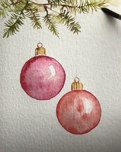 two christmas ornaments hanging from a tree branch with watercolor paint and pencils on paper