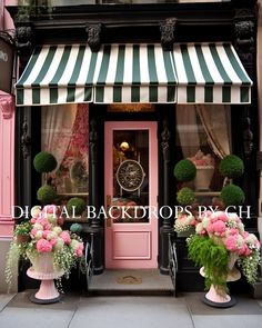 pink and green flowers are in front of a storefront with striped awnings