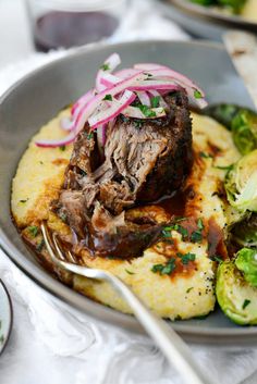 a plate with some meat and vegetables on it