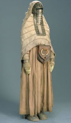 a costume worn by an unknown person in the early 20th century, possibly made from cloth and leather