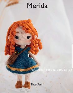 there is a crocheted doll with an orange hair wearing a blue dress and holding a brown purse