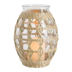 a wicker candle holder with two lit candles in the center and an open lid