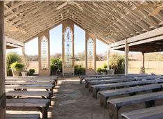 the inside of a church with pews lined up in rows and stained glass windows