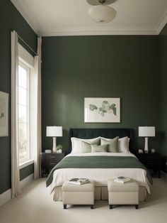 a bedroom with green walls and white furniture