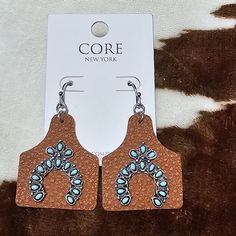 Adorable Boutique Brown Tag Earrings With Stone Design Kinda Resembling A Horseshoe. Pairs Great With Western Attire, Or Business Attire. Measures 1.5 Inches In Height And Inch Wide These Are New On Card From Smoke-Free And Pet-Free Home. Keywords: Cow Tags, Western Wear, Horseshoes, Country, Farmhouse, Business Attire, Cowgirl, Cows, Farm,Rae Dunn, Pioneer Woman, Treat Canister, Metal Canister, Handmade, Home Decor, Crystal Rhinestone Bling Stone God Silver Colorful Wedding Engagement Date Nigh Cow Tag Earrings, Cows Farm, Earrings With Stones, Cow Tag, Bohemian Sweater, Teardrop Diamond, Metal Canisters, Scarf Jacket, Glitter Shirt