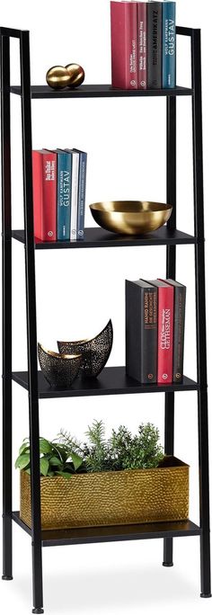 a book shelf with books, bowls and plants on it's top tiers