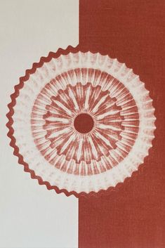 a red and white wall with a circular design on it