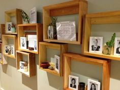 some wooden shelves with pictures and frames on them