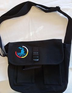 Embroidered canvas bag. Unisex. Messenger bag style, one large main interior pocket, two smaller Velcro close pockets on outside. Adjustable shoulder strap. Loop and buckle fastener. measurements 10inX9inX3.5in thank you for looking we are a small family run Native American business, all items are made in house. Michigan roots with a medicine wheel embroidery design Embroidered Cotton Shoulder Bag For School, Canvas Shoulder Bag With Embroidered Logo And Rectangular Shape, Embroidered Canvas Shoulder Bag For Travel, Canvas Shoulder Bag With Embroidered Logo, Cotton Crossbody Satchel For School, Casual Shoulder Bag With Embroidered Logo For Travel, Casual Travel Shoulder Bag With Embroidered Logo, Canvas Satchel With Multiple Pockets, Travel Crossbody Shoulder Bag With Embroidered Logo