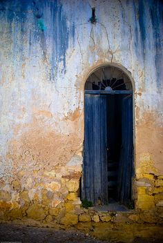 an old building with a blue door and window