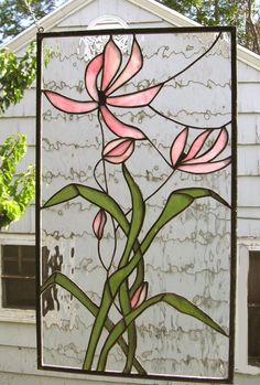 a stained glass window with pink flowers on it