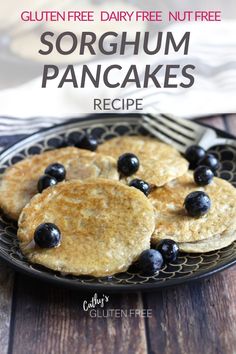 pancakes with blueberries are on a black plate