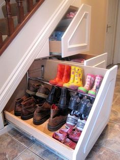 an under the stairs shoe rack holds many pairs of shoes