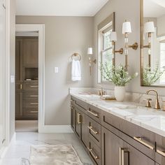 a large bathroom with two sinks and mirrors