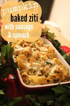 pumpkin baked ziti with sausage and spinach in a casserole dish on a holiday table