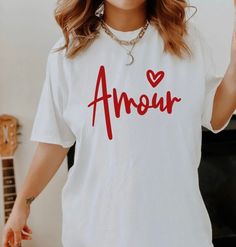 Valentines Amour tshirt, Valentines Shirt, Cute Heart Shirt, Couples Matching Shirt, Womens Valentines Shirt, Funny Valentines Size up 2 sizes for a slouchy oversized fit Sizes: S M L XL 2X 3X 4X 5X Handmade  Soft  Long Sleeve Size up for an oversized fit. Pair with bikers or leggings  *Unisex Fit Great for: Funny Shirt Coffee lovers Bloggers Gifts for her Gifts under $50 Christmas gift Birthday gift  Holiday gift Yoga Cute matching couples Valentines shirts  Available in a Croptop and Shirt. White Graphic Tee For Valentine's Day, White Casual Top For Valentine's Day, Casual White Top For Valentine's Day, Casual Valentine's Day Top With Text Print, Valentine's Day White Graphic Print Shirt, Valentine's Day Letter Print Crew Neck Shirt, White T-shirt With Valentine's Day Text Print, Valentine's Day White T-shirt With Text Print, Valentine Shirts Vinyl