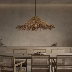 a dining room table with chairs and a large light fixture hanging over it's head