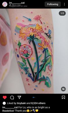 an image of a flower tattoo on someone's left arm with flowers painted on it