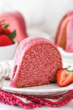 a slice of strawberry bundt cake on a plate with strawberries in the background