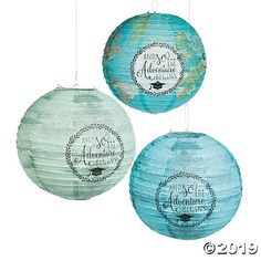 three round paper lanterns hanging from strings with words on the front and back of them