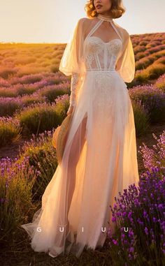 a woman wearing a white dress standing in a lavender field