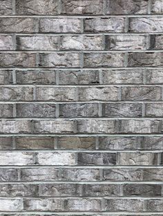 an old brick wall is shown in grey tones