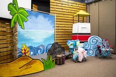 children's play area with colorful art and decor on the walls, including beach scenes