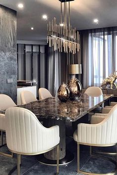 an elegant dining room with marble table and chairs