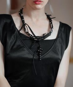 Rannka's black leather cross rosary necklace is ideal concert jewelry for alternative fashion enthusiasts. 100% adjustable you can wear it as a choker and bracelet attending a music festival or for an edgy clubbing look.  𝐒𝐈𝐙𝐄: ➤ Fully Adjustable. ➤ Circumference 51″ (130 cm) measured flat; ➤ Wrap around neck, wrist, arm, ankle, etc.  𝐃𝐄𝐓𝐀𝐈𝐋𝐒: ➤ Materials: Faux Leather, Mixed Metal, Black Acai Beads, Suede Cord ➤ Ready to Ship ★ Gift Ready -Rannka's black leather cross necklace /choker/bracelet is very flexible and provides various ways to style it.  -Made with custom made black faux leather links and mixed metal, this item features a bold black nut bead cross.   𝐇𝐎𝐖 𝐓𝐎 𝐖𝐄𝐀𝐑 𝐈𝐓? Rogue necklace/bracelet can be wrapped several times around wrist and neck with an easy lo Rocker Style Festival Choker Jewelry, Edgy Black Choker For Festivals, Black Alternative Necklace For Concert, Black Rocker Jewelry For Festival, Black Rocker Style Jewelry For Festival, Black Alternative Style Necklace For Concerts, Alternative Style Black Necklace For Concerts, Adjustable Emo Choker For Concerts, Black Gothic Jewelry For Concerts