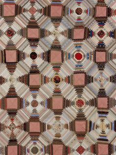 an area rug with many squares and circles on the top, in various shades of brown