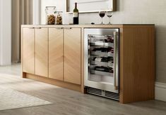 a wine cooler in the middle of a kitchen