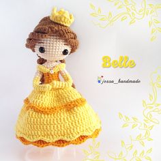 a crocheted doll wearing a yellow dress