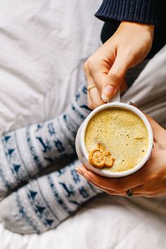 a person is holding a cup of coffee