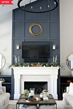 a living room with a fireplace, couches and a large mirror on the wall