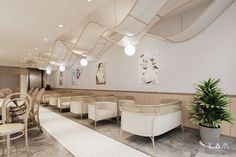 an empty restaurant with white chairs and tables