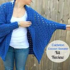 a woman wearing a blue crochet shawl with the text, carlton cocoon sweater kit review