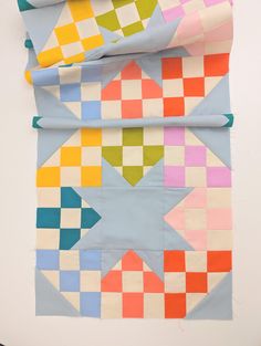 three pieces of colorful quilting laid out on top of each other