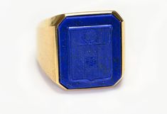 Lapis Crest Men’s Ring. Step up your style game with this exquisite vintage Men's Ring featuring a stunning Lapis Crest set in 18K gold. This eye-catching piece is perfect for those who appreciate the finer details and quality craftsmanship. The deep blue lapis lazuli is elegantly set in the warm sheen of 18K gold, providing a sophisticated touch to both casual and formal attire. Make a statement with this unique ring that combines classic elegance with modern style. Material: 18K Gold Gemstone: Luxury 14k Stamped Collectible Signet Ring, Formal Engraved Ring With Maker's Mark, Luxury 14k Gold Signet Ring With Intaglio, Luxury Formal Signet Ring With Intaglio, Luxury Yellow Gold Signet Ring With Maker's Mark, Luxury 14k Stamped Signet Ring For Formal Occasions, Luxury Formal Signet Ring Stamped 14k, Luxury Hallmarked Signet Ring For Formal Occasions, Luxury Hallmarked Formal Signet Ring