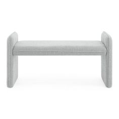 a gray bench sitting on top of a white floor