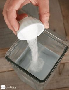 a person pouring water into a container