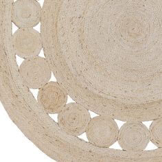 an oval rug with several circles on the center and one circle in the middle that is made from jute