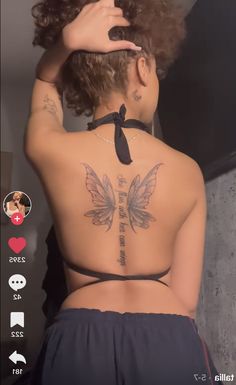 the back of a woman's body with tattoos on it