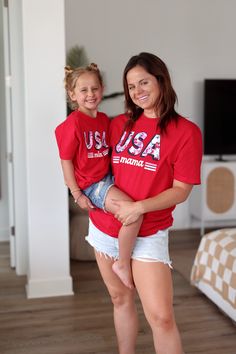 Show your love for the USA with our comfy USA Mama tee!! Whether you are celebrating the Fourth Of July or running errands this is the perfect tee for all the moms!! Please note that our TSL tees run about 1/2 a size smaller than our Jadelynn Brooke tees. *Model is wearing a medium* 100% cotton Measurements By Size Small 2/4 Medium 6/8 Large 10/12 XL 14/16 XXL 18/20 Mom mother madre mum mommy ma momma patriotism motherhood stars and stripes flag america us freedom proud red, white and blue Family Matching Short Sleeve T-shirt For 4th Of July, Family Matching T-shirts For 4th Of July, Family Matching Game Day Tops With Short Sleeves, Family Matching Crew Neck T-shirts For 4th Of July, Casual Red Top For Family Occasions, Family Matching Red T-shirt For Summer, Family Matching Red Tops With Letter Print, Red Graphic Print T-shirt For Family Matching, Red Short Sleeve T-shirt For Family