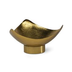 a gold bowl sitting on top of a white surface