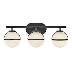 three light bathroom fixture with black finish and white glass globes on the front side