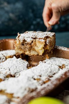 a person is cutting into some dessert on a tray