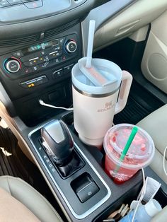 a cup and drink in the center console of a car