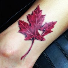 a red maple leaf tattoo on the foot