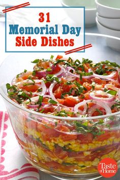 a glass bowl filled with lots of food on top of a table