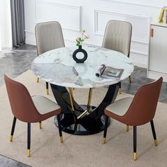 a marble dining table with four chairs around it